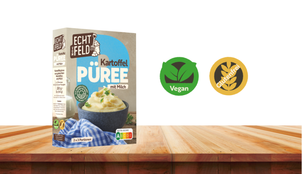 Kartoffelpüree mit Milch Packung von Echt vom Feld auf einem Holztisch stehend. Daneben Symbole für vegan und glutenfrei.