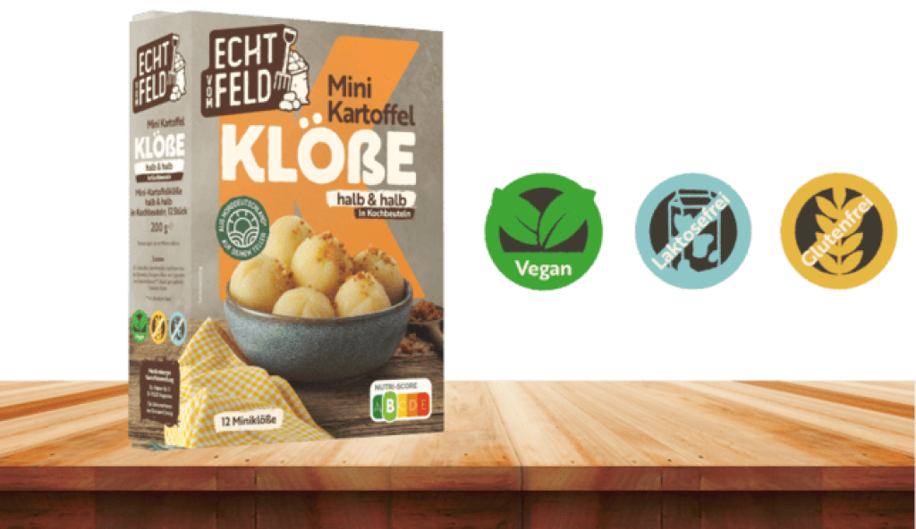 Vegane, laktosefreie und glutenfreie Kartoffelklöße von Echt vom Feld auf einem Holztisch stehend.